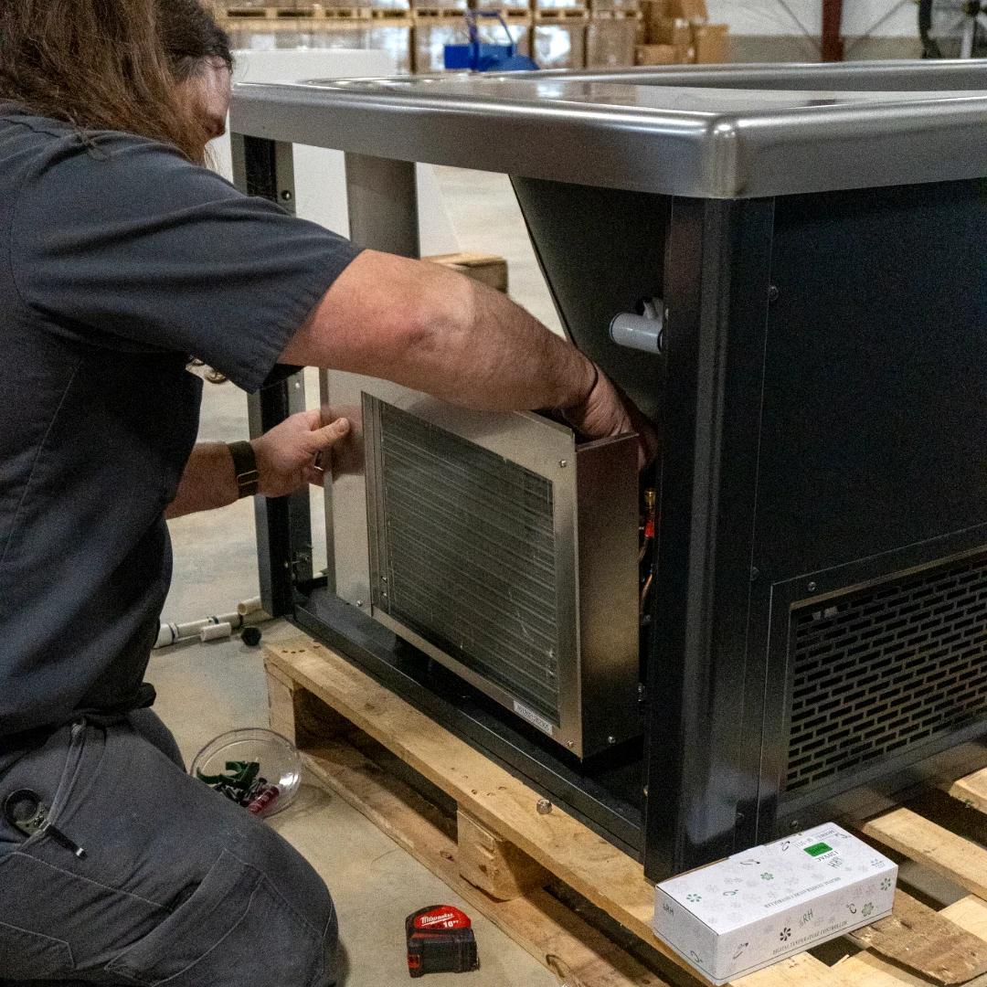 Beyond Cold technician installing the cooling system into a Summit cold plunge
